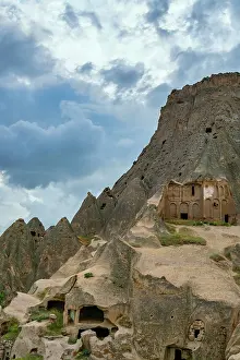 Settlement Prints: Exploring Selime ancient town with rock-carved houses in Cappadocia during a cloudy day