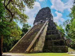 Pyramid Prints: Exploring Temple V at Tikal reveals ancient Mayan architecture in Guatemala amidst nature