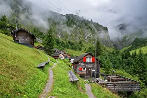 Homes Prints: Exploring Tschinglengorge and traditional buildings in Sardona National Park during a cloudy day in Elm