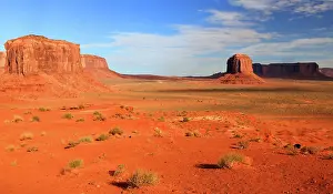Dirt Prints: Exploring the vast landscape of Monument Valley against a clear sky in Navajo Indian Territory in Utah