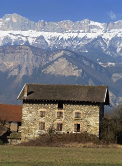 Savoie Prints: Exterior of a stone farm house and mountains near Chambery, with Mont Granier behind