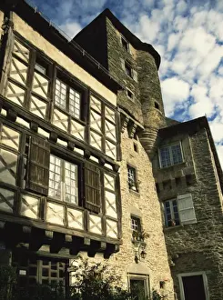 Limousin Prints: Exterior of stone house with wooden windows and turret in the village of Segur le Chateau
