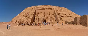 Nubia Prints: Exterior view of tourists and massive sculptures at the Abu Simbel Temple next to Lake Nasser