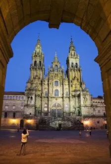 Images Dated 15th March 2006: Facade of cathedral seen from Praza do Obradoiro floodlit at night, with a woman taking a photograph