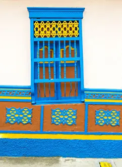 Colombia Prints: The facade of a colourful building covered in traditional local tiles, in the picturesque