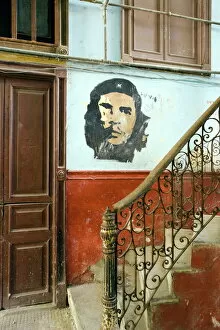 Cuba Gallery: Faded mural of Che Guevara on the staircase of a dilapidated apartment building