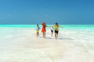 Kids Prints: Family with two boys having fun running together on idyllic beach