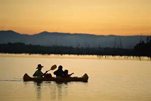 Canoe Prints: Family canoeing on Lake Tinaroo, a recreation area on the Atherton Tableland in Queensland