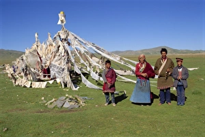 Qinghai Prints: A family standing beside prayer flags at Huashixia in Qinghai, China, Asia