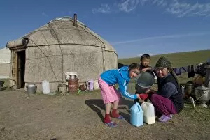 Family in front of their yurt, Song Kul, Kyrgyzstan, Central Asia, Asia