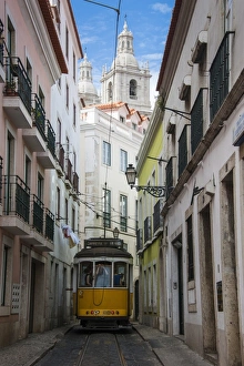 Alfama Prints: Famous tram 28 going through the old quarter of Alfama, Lisbon, Portugal, Europe