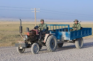 Farmers working with tractor, Sary Tash, Kyrgyzstan, Central Asia
