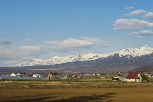 Farmland below the mountains of the Daisetsuzan National Park, UNESCO World Heritage Site