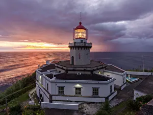 Lighthouses Prints: Farol do Arnel lighthouse at sunrise in a cloudy morning