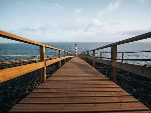 Lighthouses Prints: Farolim dos Fenais da Ajuda lighthouse with a symmetrical wooden path leading to it