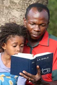 Books Prints: Father and daughter reading the Bible, Lome, Togo, West Africa, Africa
