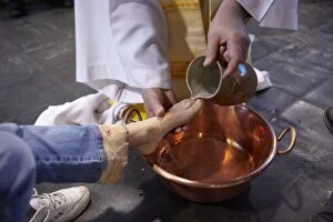 Feet washing ritual during Maundy Thursday celebration in a Catholic church