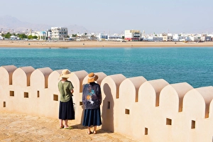 Friendship Prints: Two female tourists by crenelated wall of lighthouse