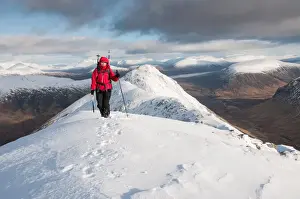 Winter Scene Prints: A female walker approaching the summit of Stob Dubh on Buchaille Etive Beag on a