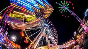Ferris Wheel Prints: Ferris Wheel and various other funfair rides at night at Nottinghams Goose Fair