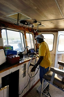 Steering Prints: Ferry captain, St. Kitts and Nevis, Leeward Islands, West Indies, Caribbean, Central