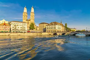 Rippled Prints: Ferry along Limmat River next to Munsterbrucke bridge with Grossmunster in background