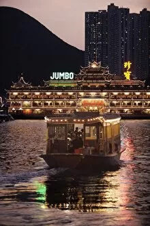 Ferry sailing towards Jumbo floating restaurant at dusk, Aberdeen harbour