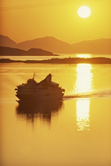 Ferry silhouetted by the midnight sun