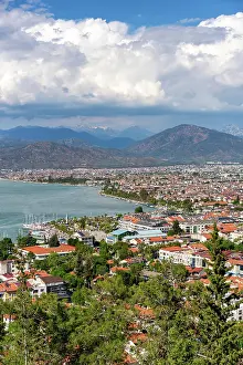 Cityscapes Prints: Fethiye offers a stunning city view on a sunny day with mountains in the background and a calm sea in Turkey