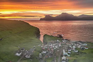 Gjogv Prints: Fiery sky at dawn over Kalsoy island and the village of Gjogv