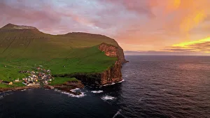 Gjogv Prints: Fiery sky at dawn over the village of Gjogv ovelooking the ocean