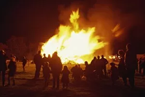 Figures silhouetted against bonfire for Guy Fawkes Night, United Kingdom, Europe