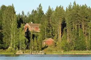 Images Dated 18th August 2010: Finnish summer house on a wooded island in Lake Saimaa by sunset light, near Savonlinna, Finland