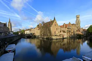 Bruges Prints: First light of dawn on the Belfry and historic buildings reflected in the typical canal