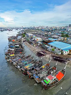 Stalls Prints: Fish market in Chittagong shows busy activity with many boats and people in the area during daytime