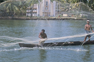 Fisherman casting his throw net in the coastal backwaters