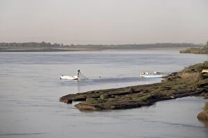 A fisherman checks his nets on the Nile river at Karima