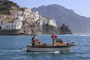 Fisherman Prints: Fisherman in fishing boat heads out to sea from Amalfi harbour