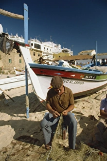 Fishing Net Prints: Fisherman fixing nets on beach