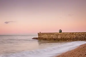 Fisherman Prints: Fisherman and the Green Doughnut sculpture at dawn on Brighton Seafront, Brighton