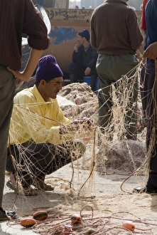 Fishing Net Prints: Fisherman repairing net