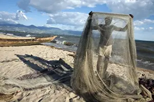 Fishing Net Prints: A fisherman tends his nets on Plage des Cocotiers (Coconut Beach) also known as Saga Beach