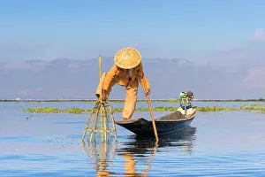 Fishing Net Prints: Fisherman with traditional conical net on boat