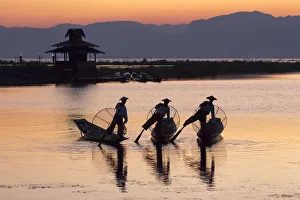 Fisherman Prints: Three fishermen balance on one leg at sunset on Inle Lake, Shan State, Myanmar (Burma)