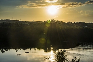 Jinja Prints: Fishermen in their canoes fishing at sunset on the Nile at Jinja