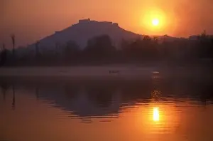 Multi Color Prints: Fishermen make their way home in canoes as the sun sets over Nigeen Lake