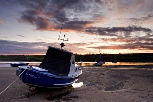 Fishing boat on the Aln Estuary at sunset, Alnmouth, near Alnwick, Northumberland