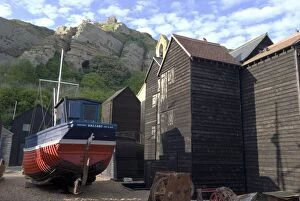 Fishing boat and historic buildings with Hastings Castle in the background