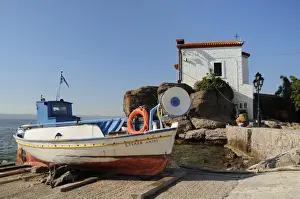 Chapels Prints: Fishing boat Stella on ramp near small chapel at Skala Sikaminia