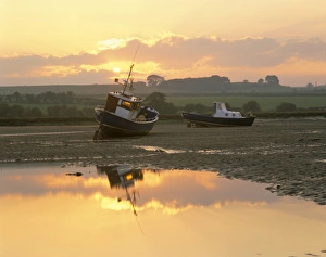 Alnmouth Prints: Fishing boat at sunset on the Aln estuary at low tide, Alnmouth, Northumberland